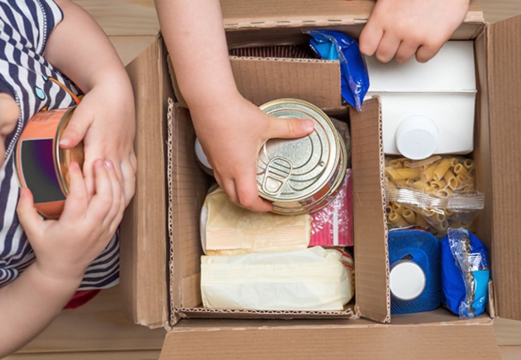 Children Opening A Food Delivery Box At Home, Online Ordering. Grocery Store Delivery. Box Full Of Food In Concept Donation Boxparcel. Delivery During Quarantine Due To Coronavirus Covid 19 Disease